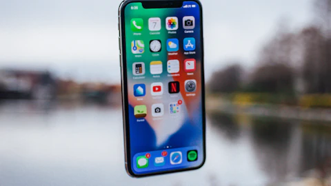iPhone plateado flotando sobre una palma abierta